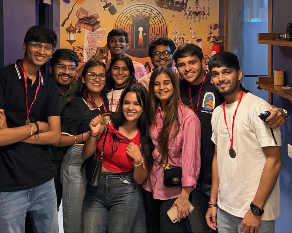 A group of colleagues celebrating their successful escape room challenge during a corporate team building event.