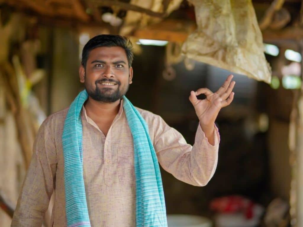 Smiling Indian man in traditional attire making gesture in Bhuj, Gujarat
