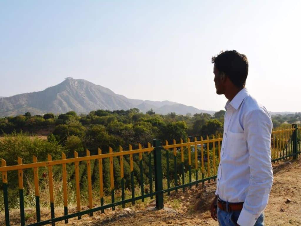 Man admiring scenic mountain view at Saputara hill station in Gujarat