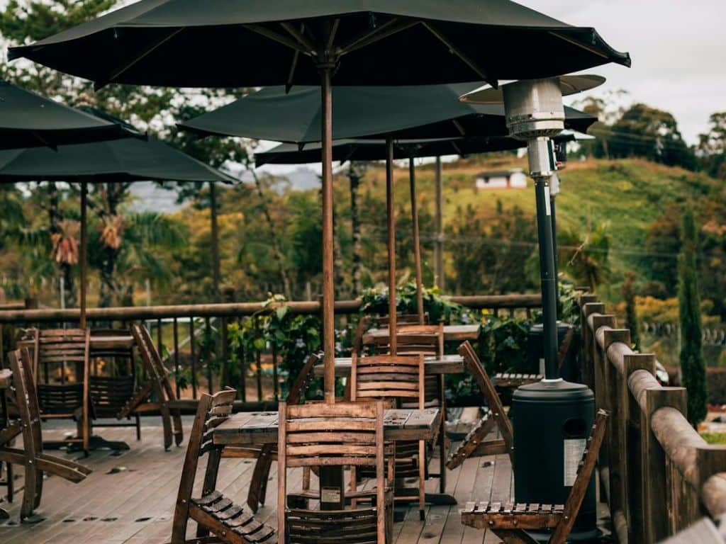 Cozy outdoor café seating with umbrellas and scenic views in Ahmedabad.