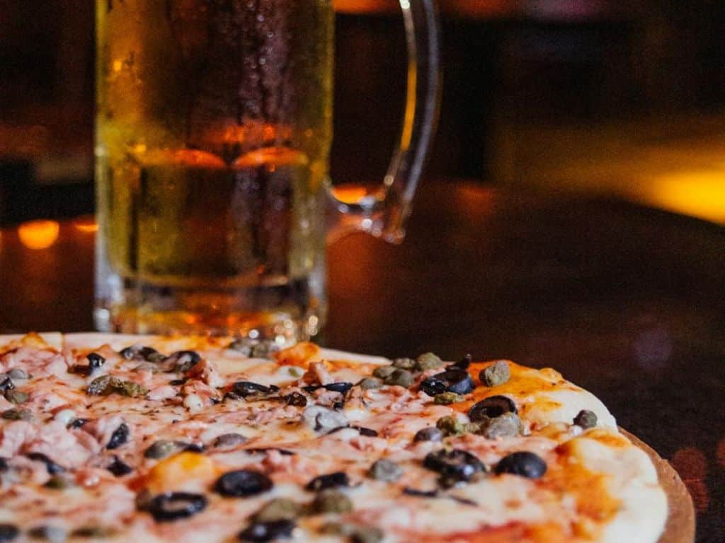 Romantic dinner with pizza and drinks at a cozy restaurant in Ahmedabad.