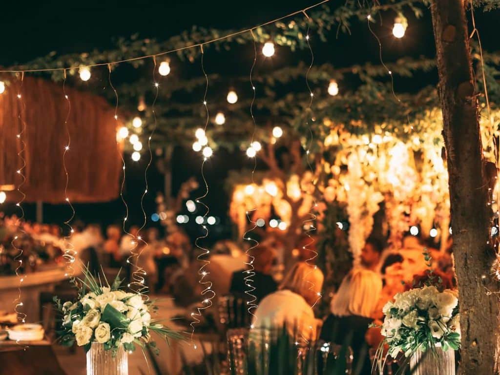 Romantic outdoor restaurant with fairy lights and floral decor in Ahmedabad.