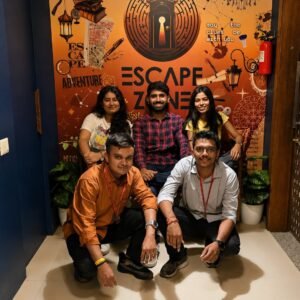 Team posing in front of the Escape Zone mural in the lobby