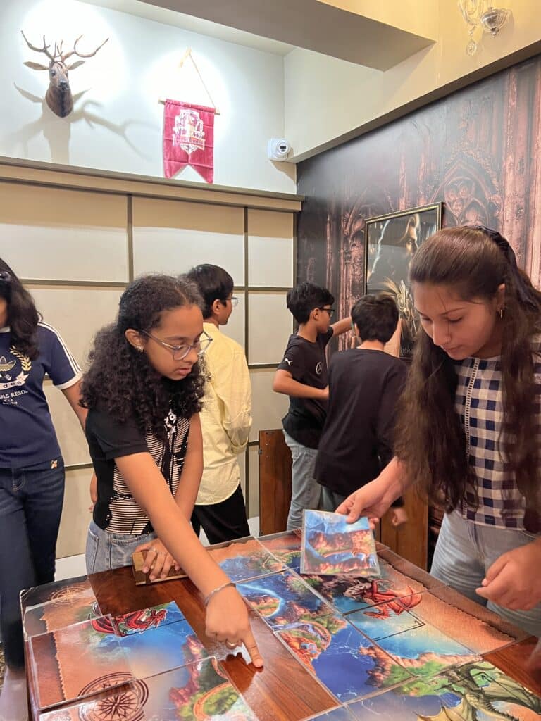 Group of siblings solving clues together inside Escape Zone Ahmedabad's pirate-themed escape room, a memorable Raksha Bandhan activity in Ahmedabad