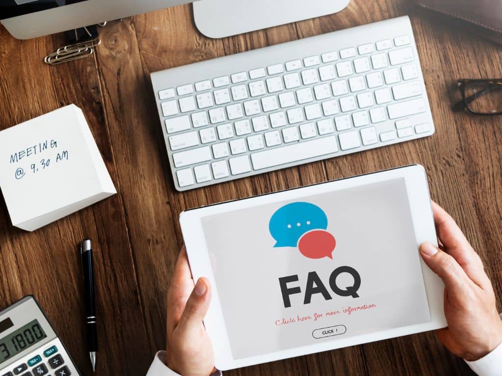 Person holding a tablet showing FAQ, answering common questions about the best rakhi gift ideas in Ahmedabad for Raksha Bandhan at Escape Zone