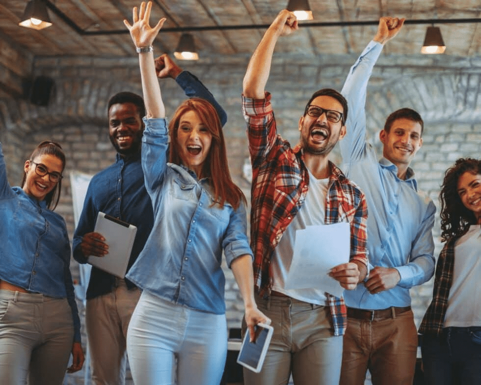 Group of friends cheering with their arms raised