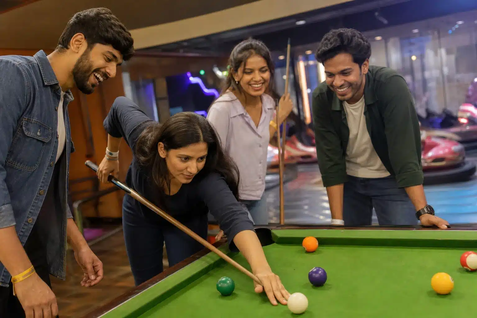 Friends gathered around a pool table in a mall game zone.
